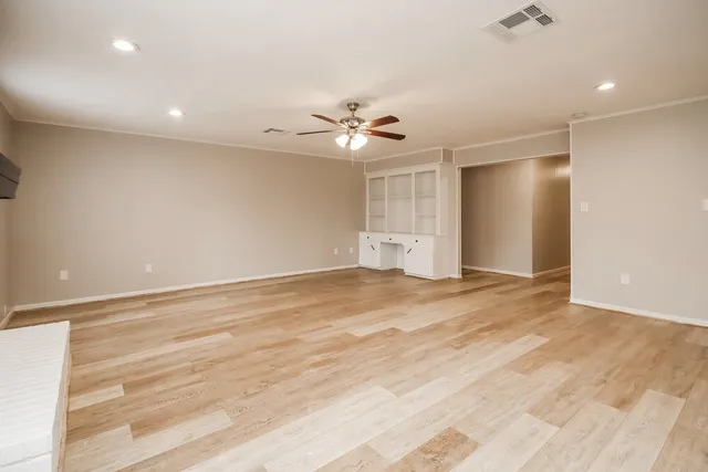 an empty room with fan and a ceiling fan