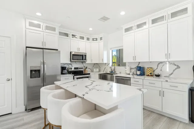 a bedroom with two beds and a chandelier