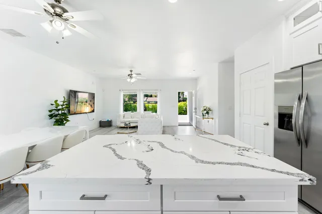 a bedroom with two beds and painting on the wall