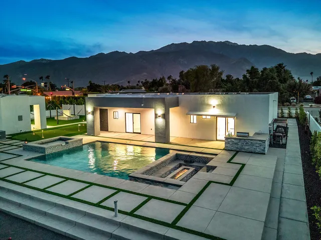 a view of a house with a yard and a lake view