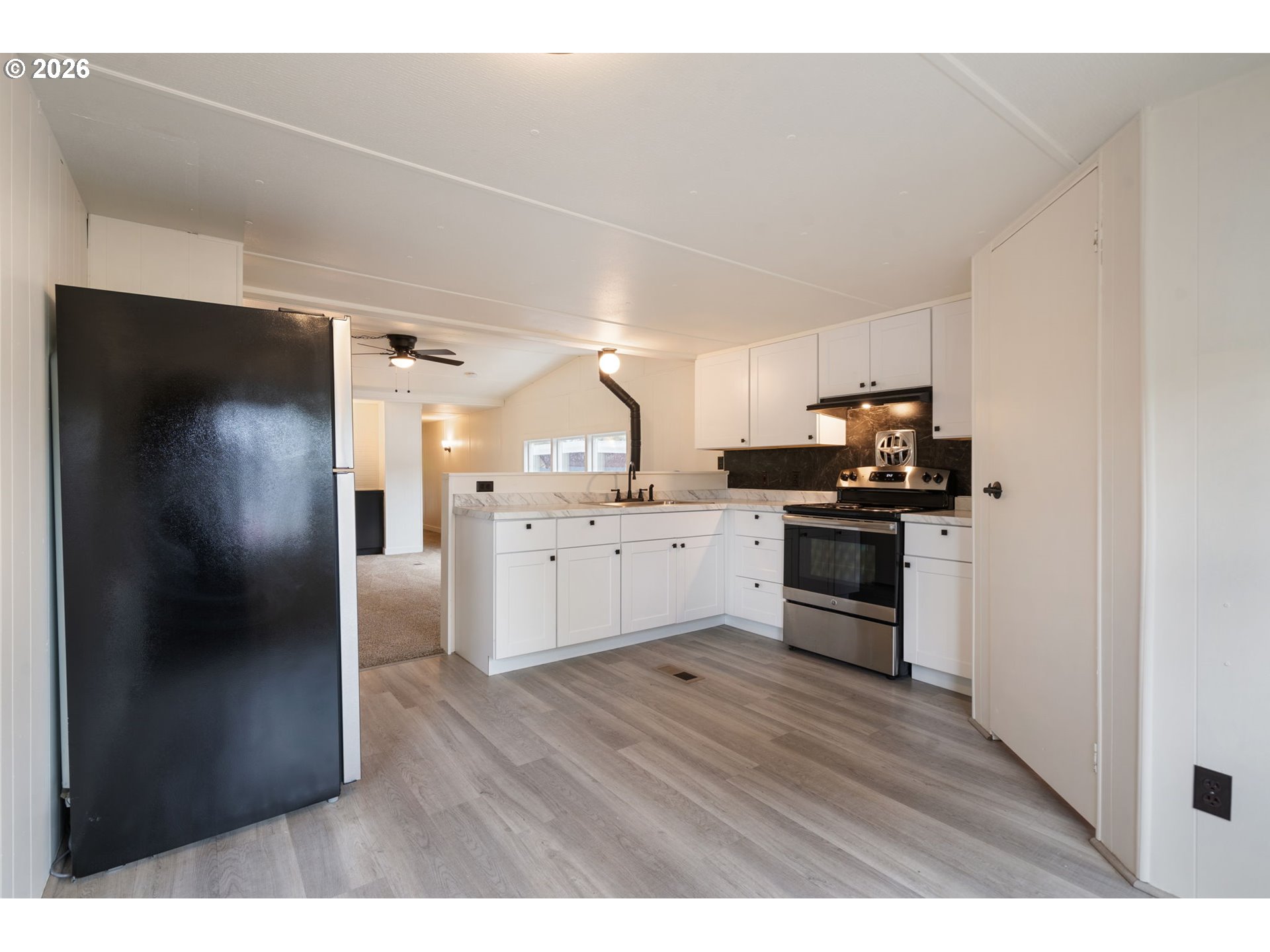 15130 South Maplelane Road, Unit 50 Oregon City, OR 97045 - Photo 11 of 36 a kitchen with cabinets and stainless steel appliances