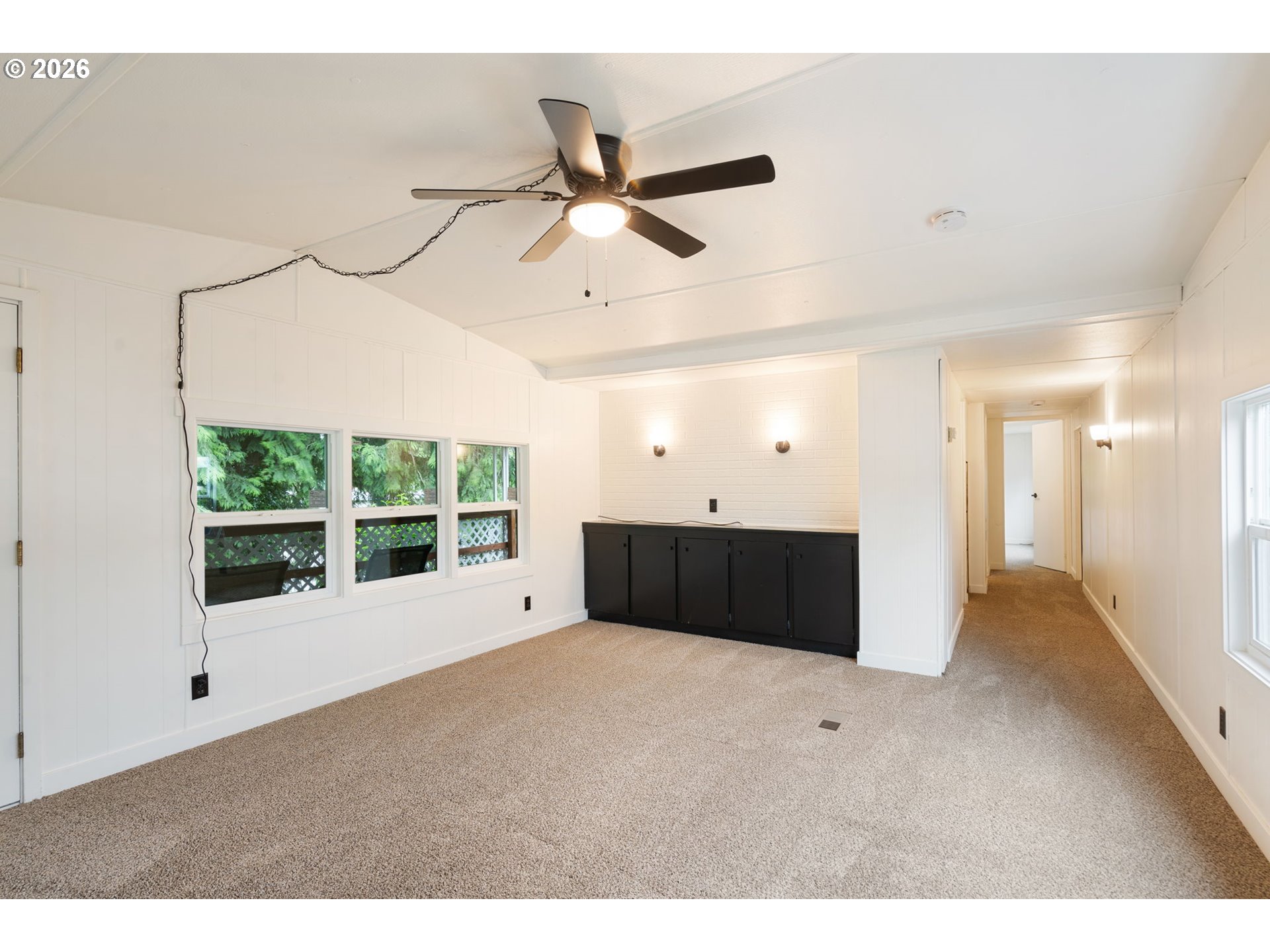 15130 South Maplelane Road, Unit 50 Oregon City, OR 97045 - Photo 15 of 36 a living room with a large window and a ceiling fan