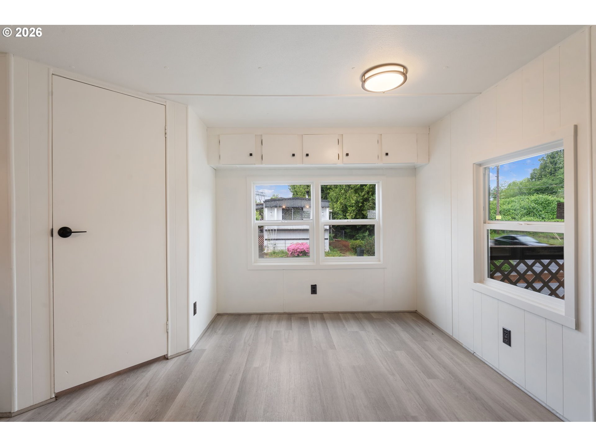 15130 South Maplelane Road, Unit 50 Oregon City, OR 97045 - Photo 18 of 36 a view of an empty room with wooden floor and a window