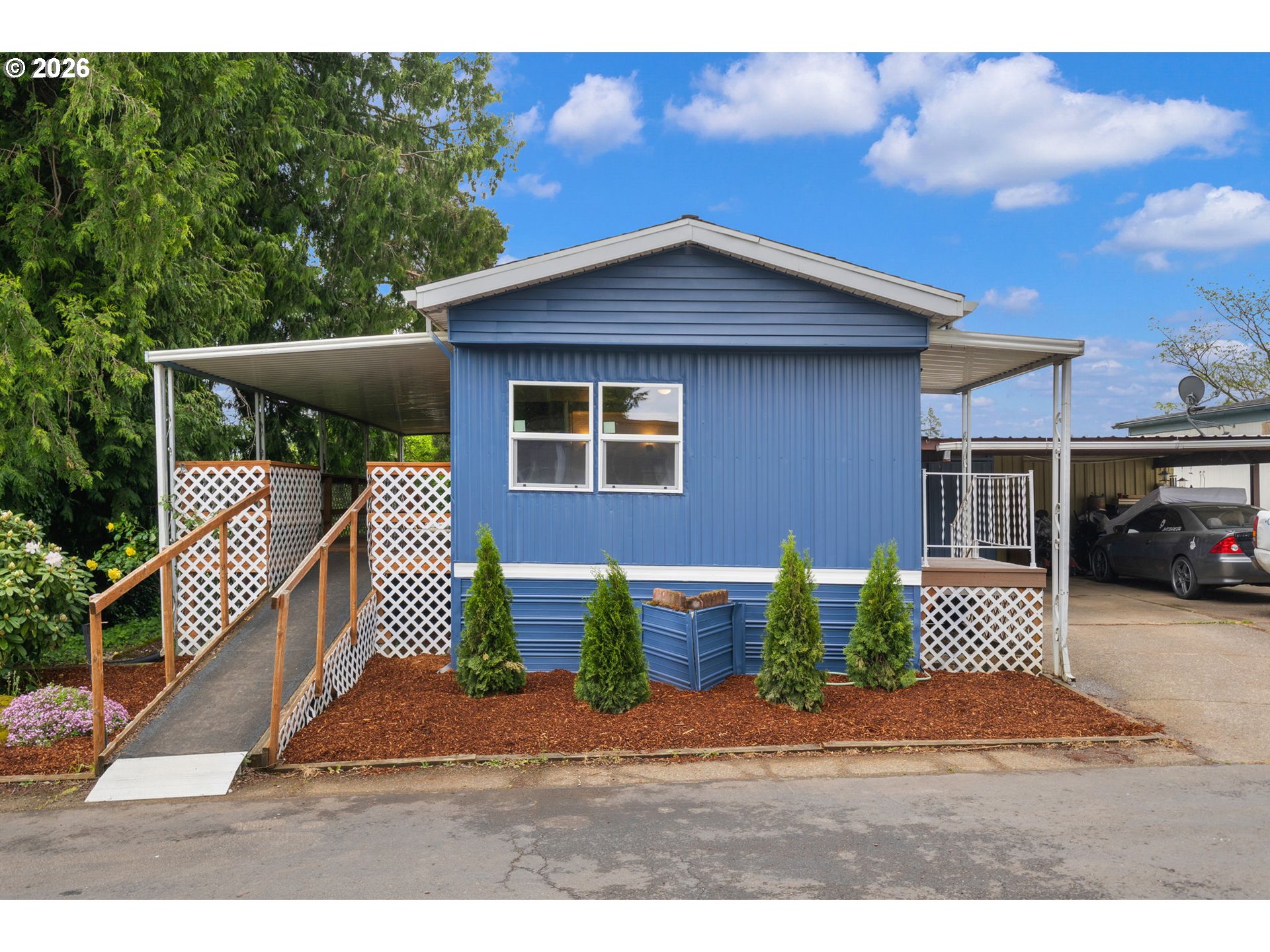 15130 South Maplelane Road, Unit 50 Oregon City, OR 97045 - Photo 2 of 36 a front view of a house with garden