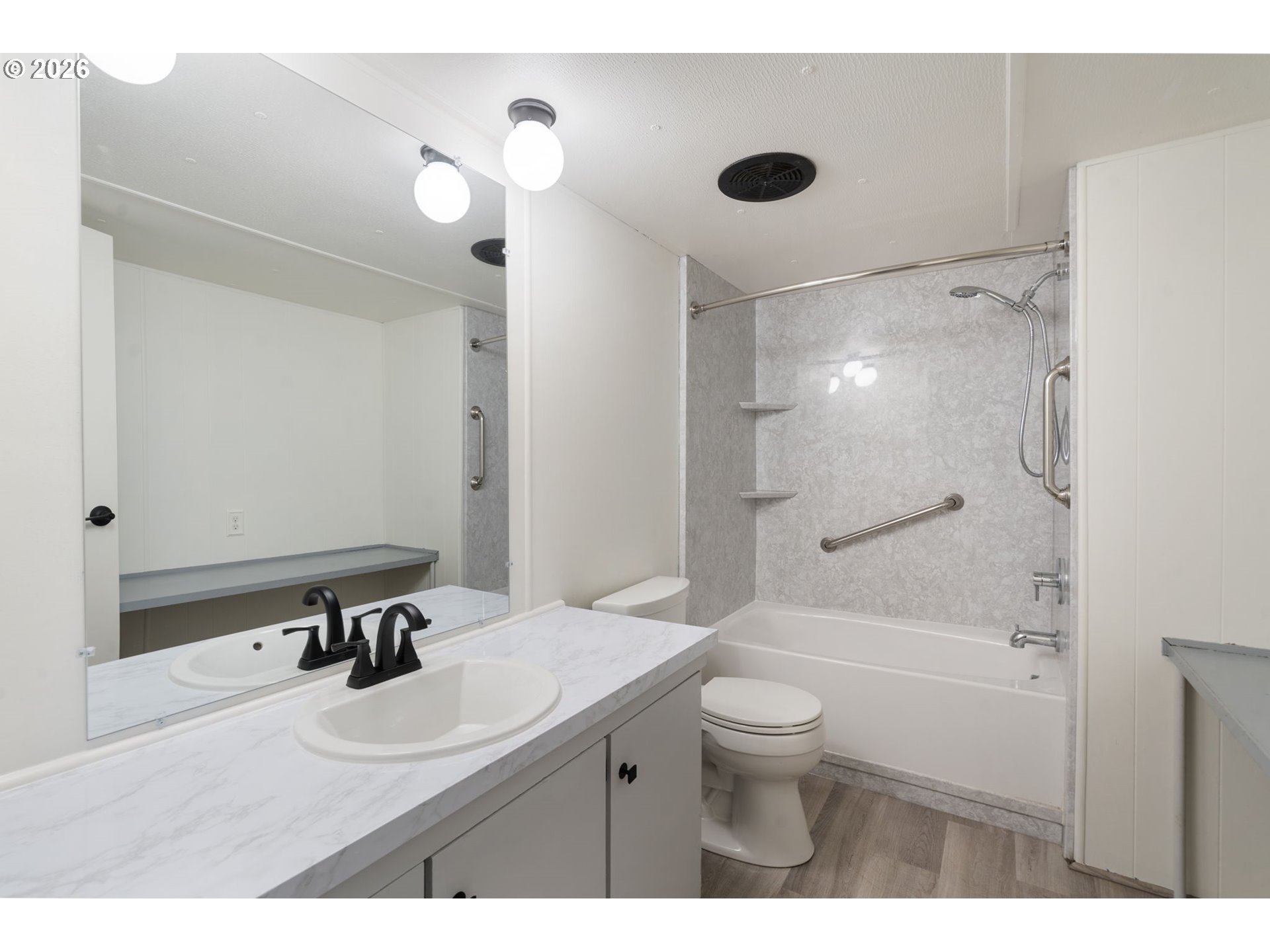 15130 South Maplelane Road, Unit 50 Oregon City, OR 97045 - Photo 21 of 36 a bathroom with a sink a toilet a mirror and shower