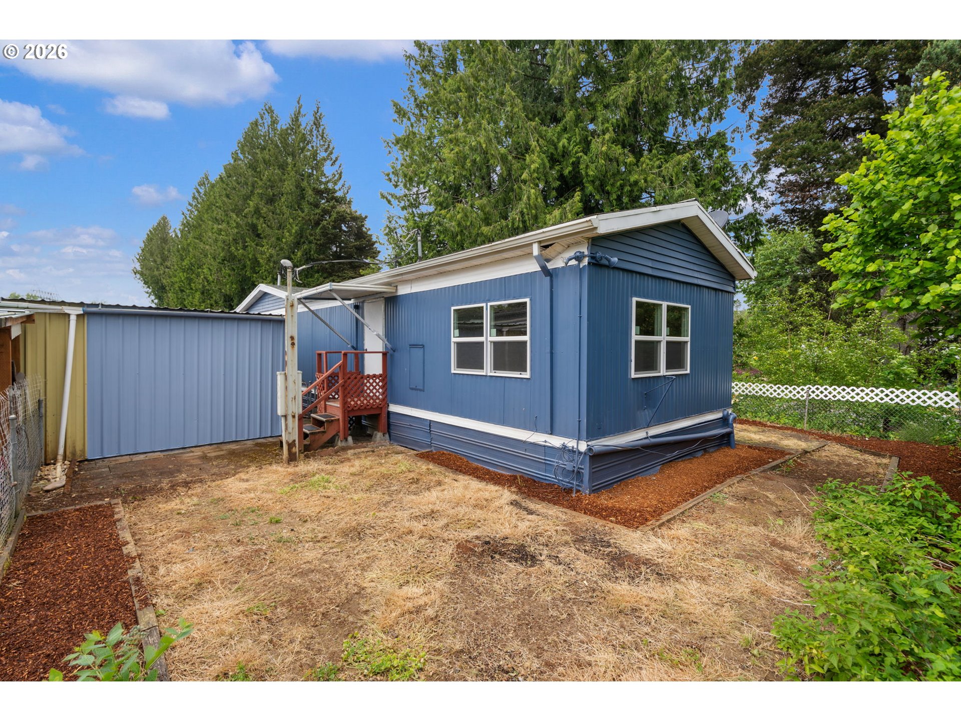15130 South Maplelane Road, Unit 50 Oregon City, OR 97045 - Photo 32 of 36 a view of a backyard with a barn and a yard