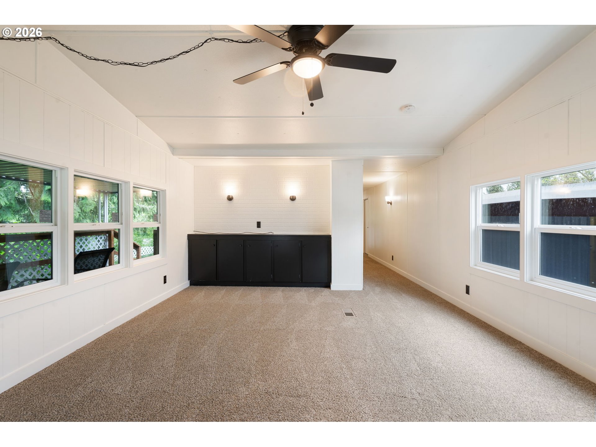 15130 South Maplelane Road, Unit 50 Oregon City, OR 97045 - Photo 5 of 36 a view of an empty room with a window and kitchen view