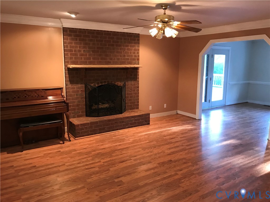 2395 State Rte 635 Midlothian, VA 23113 - Photo 14 of 38 a living room with wooden floor and a fireplace