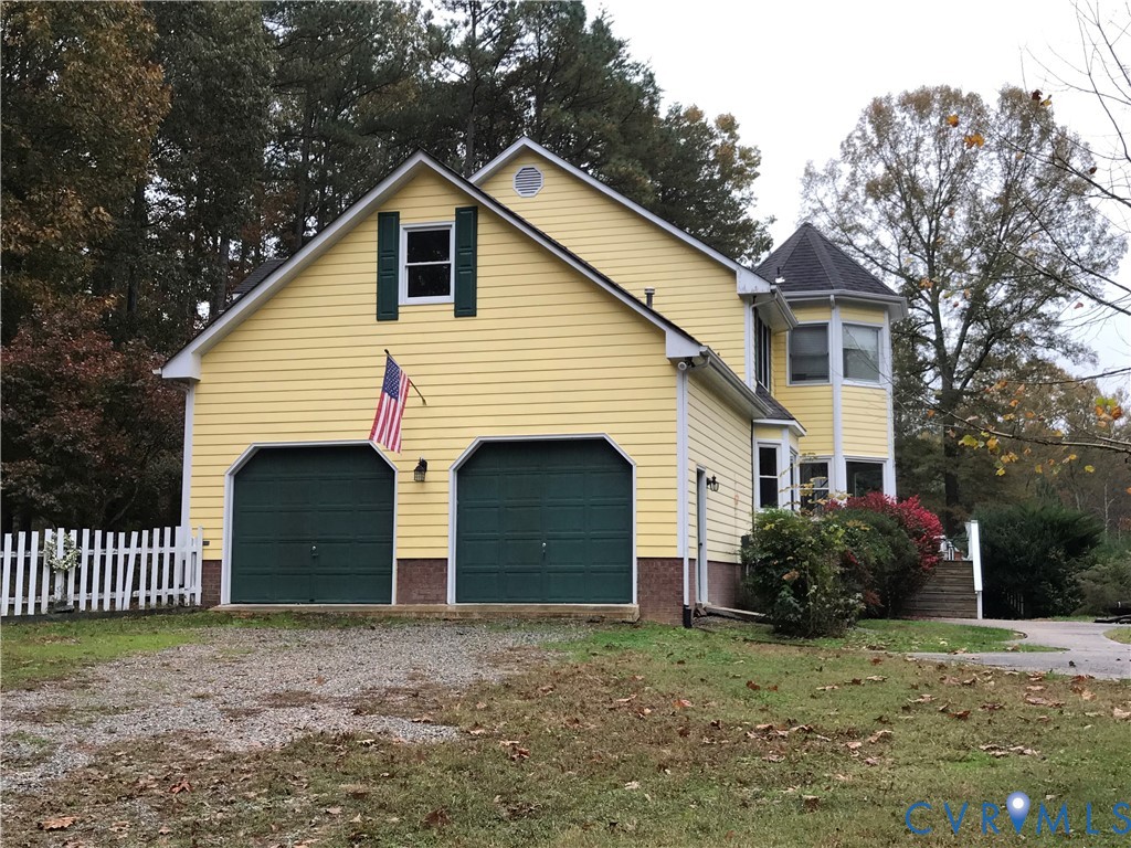2395 State Rte 635 Midlothian, VA 23113 - Photo 37 of 38 a front view of a house with a yard and garage