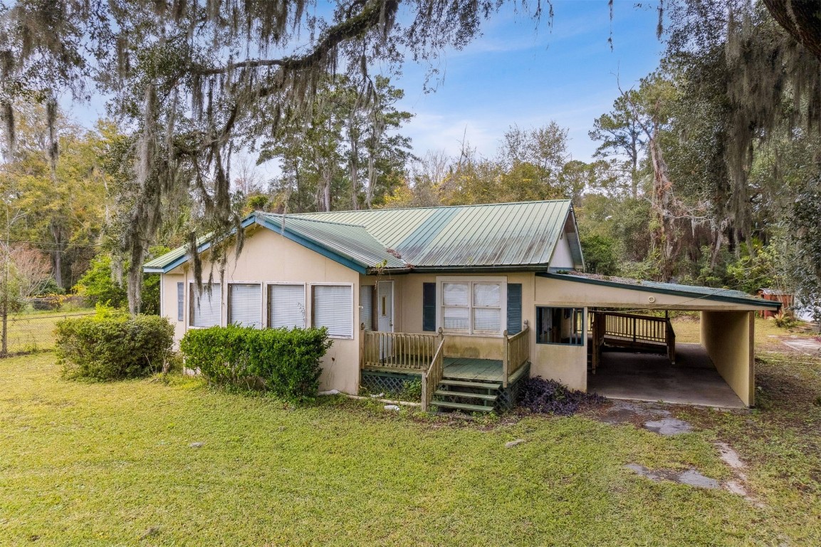 463465 State Road 200 Yulee, FL 32097 - Photo 12 of 20 a view of a house with backyard and sitting area