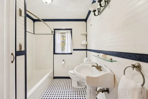 a bathroom with a sink a mirror and a shower
