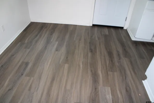 a view of a room with wooden floor