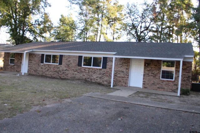 front view of a house with a tree
