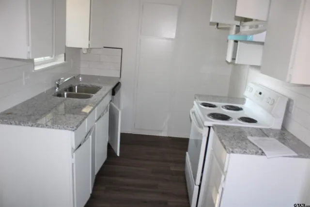 a utility room with sink washer and dryer