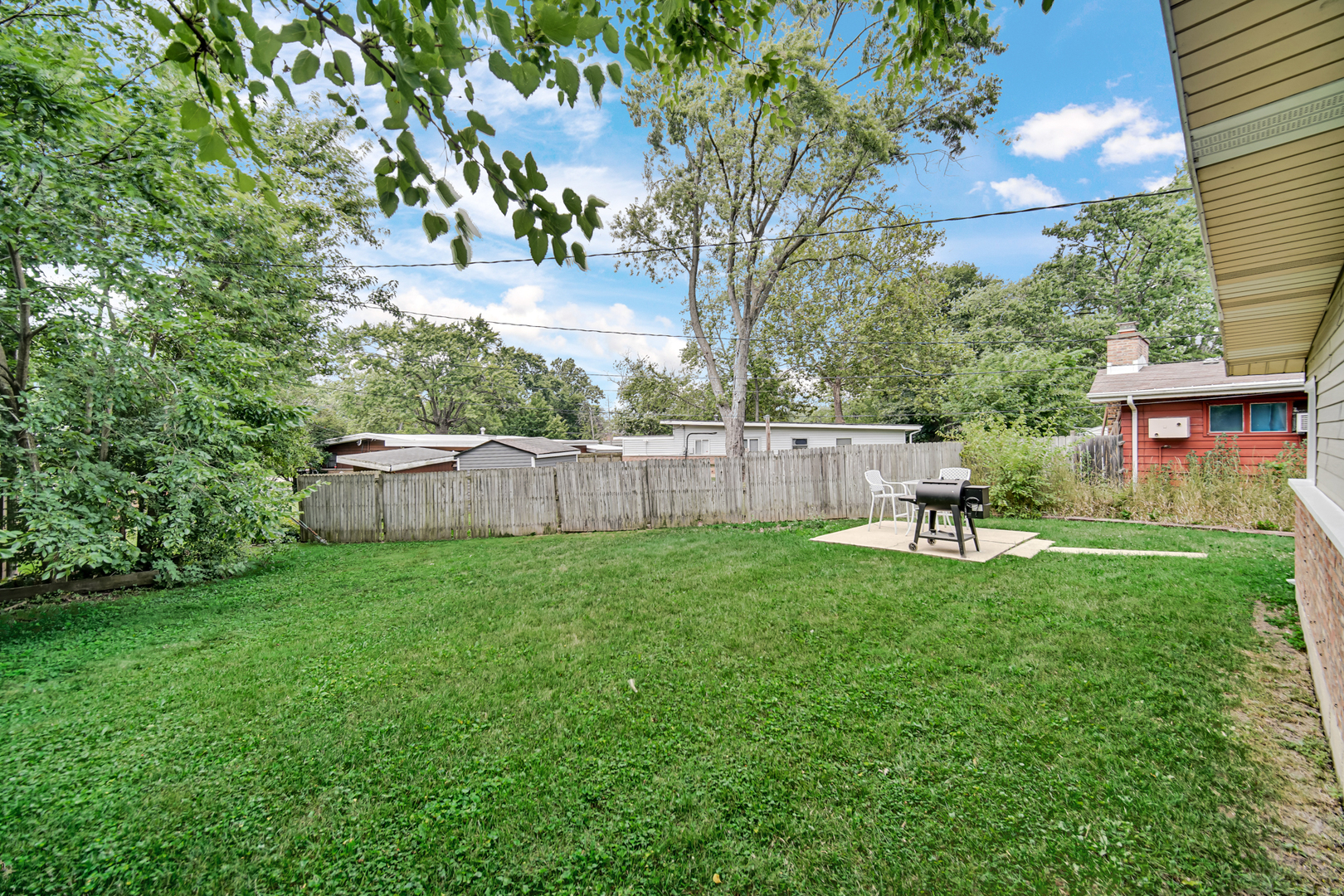 263 Sangamon Street Park Forest, IL 60466 - Photo 17 of 17 a backyard of a house with table and chairs