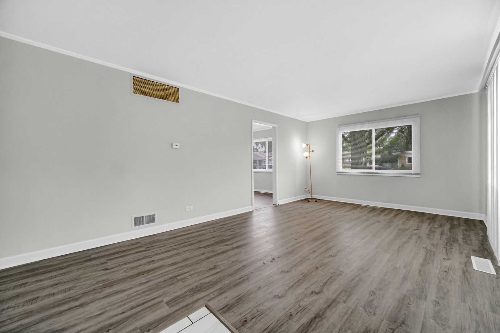 263 Sangamon Street Park Forest, IL 60466 - Photo 4 of 17 an empty room with wooden floor and windows