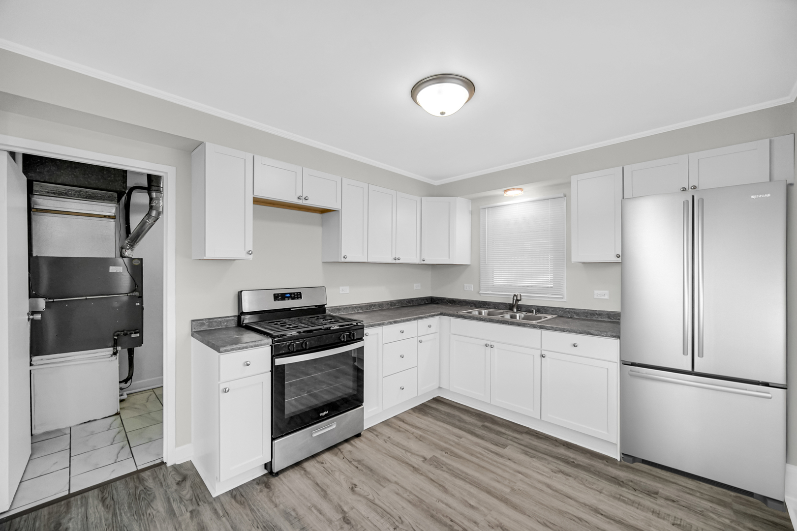 263 Sangamon Street Park Forest, IL 60466 - Photo 7 of 17 a kitchen with granite countertop a refrigerator stove top oven and sink