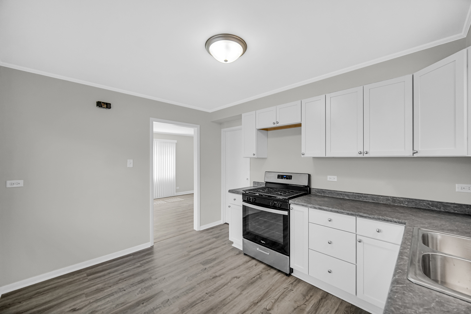 263 Sangamon Street Park Forest, IL 60466 - Photo 8 of 17 a kitchen with granite countertop white cabinets and appliances