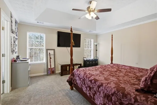a bedroom with a large bed and a flat screen tv