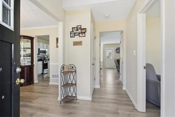 a view of hallway with livingroom and furniture