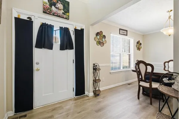 a view of a livingroom with furniture window and wooden floor