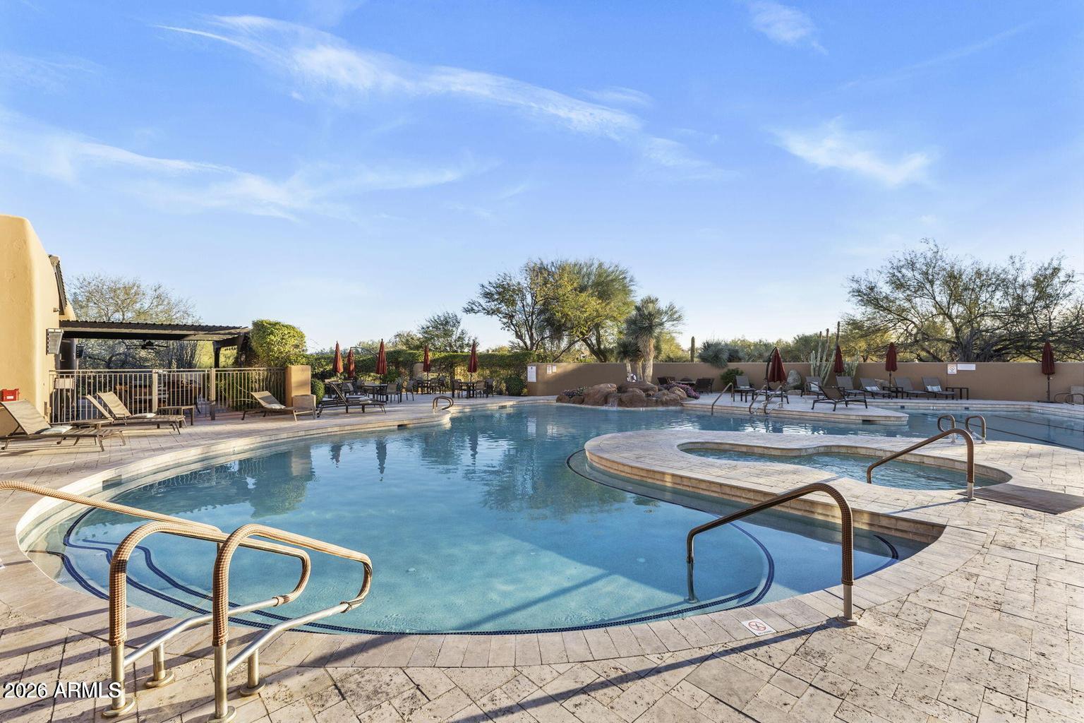 18602 Amarado Circle Rio Verde, AZ 85263 - Photo 52 of 58 a view of a swimming pool with outdoor seating and plants