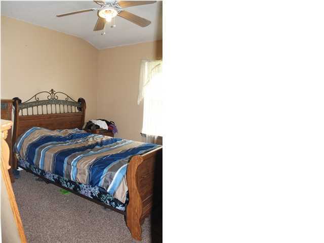 1492 McCauley Road Baker, FL 32531 - Photo 11 of 16 a bedroom with a bed and a chandelier