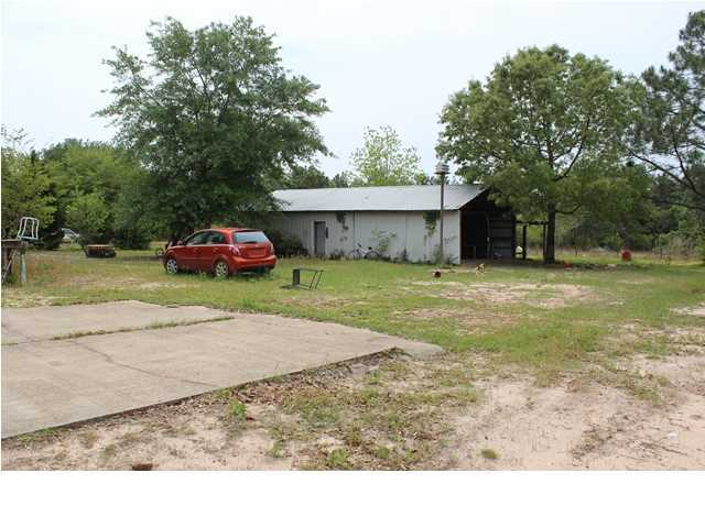 1492 McCauley Road Baker, FL 32531 - Photo 15 of 16 a backyard of a house with yard and trampoline
