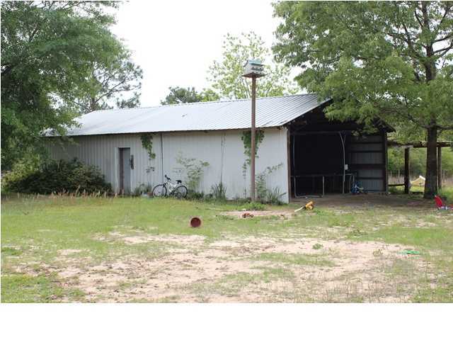 1492 McCauley Road Baker, FL 32531 - Photo 16 of 16 a backyard of a house with barbeque oven
