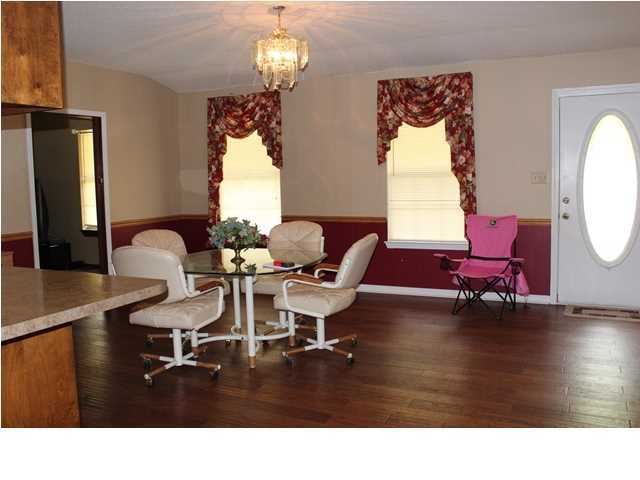 1492 McCauley Road Baker, FL 32531 - Photo 6 of 16 a living room with furniture chandelier and a wooden floor