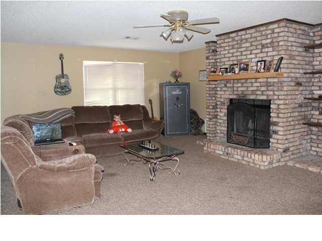 1492 McCauley Road Baker, FL 32531 - Photo 7 of 16 a living room with furniture and a fireplace