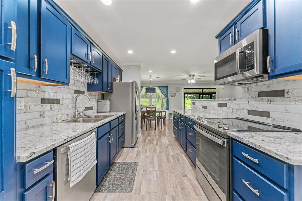 19660 Southwest 83rd Place Road, Unit C13 Dunnellon, FL 34432 - Photo 12 of 52 a kitchen with stainless steel appliances granite countertop a sink stove and cabinets