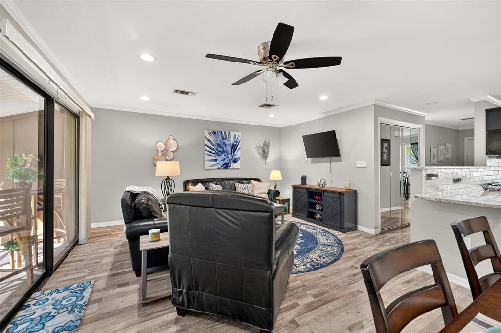 19660 Southwest 83rd Place Road, Unit C13 Dunnellon, FL 34432 - Photo 20 of 52 a living room with furniture and a flat screen tv