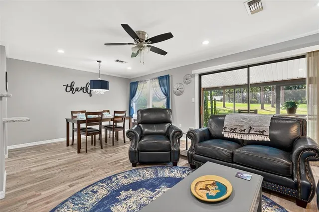 a living room with furniture a window and a chandelier