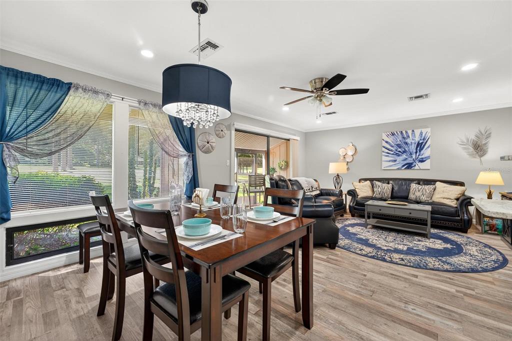 19660 Southwest 83rd Place Road, Unit C13 Dunnellon, FL 34432 - Photo 24 of 52 a living room with furniture a window and a chandelier