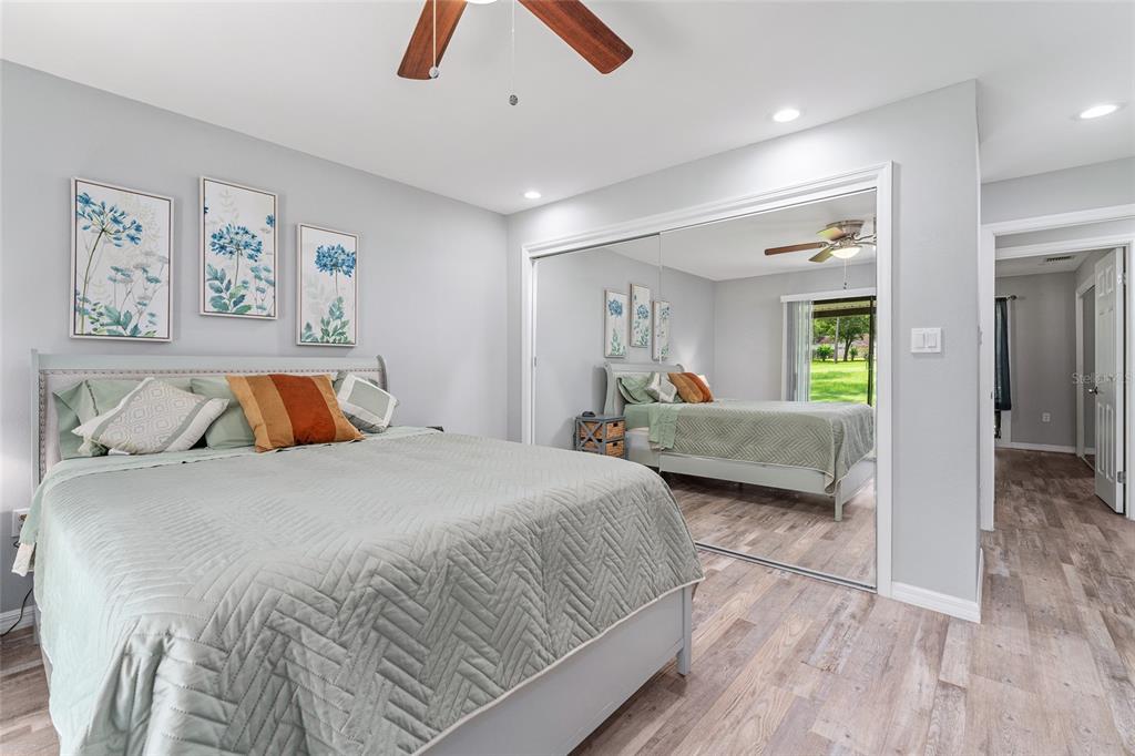 19660 Southwest 83rd Place Road, Unit C13 Dunnellon, FL 34432 - Photo 32 of 52 a bedroom with double bed and a large mirror