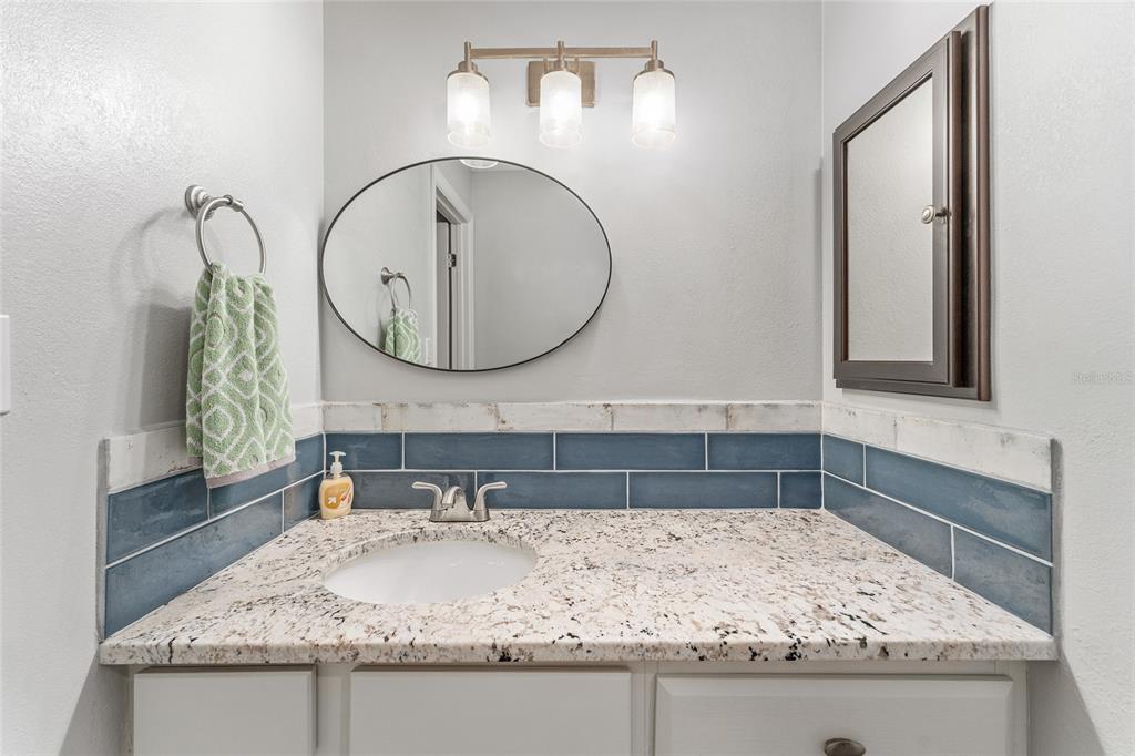 19660 Southwest 83rd Place Road, Unit C13 Dunnellon, FL 34432 - Photo 35 of 52 a bathroom with a granite countertop sink and a mirror
