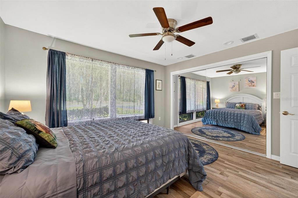 19660 Southwest 83rd Place Road, Unit C13 Dunnellon, FL 34432 - Photo 40 of 52 a bedroom with a large bed and a large window