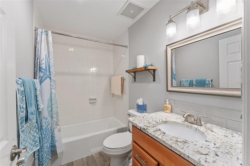 19660 Southwest 83rd Place Road, Unit C13 Dunnellon, FL 34432 - Photo 41 of 52 a bathroom with a granite countertop sink toilet and shower