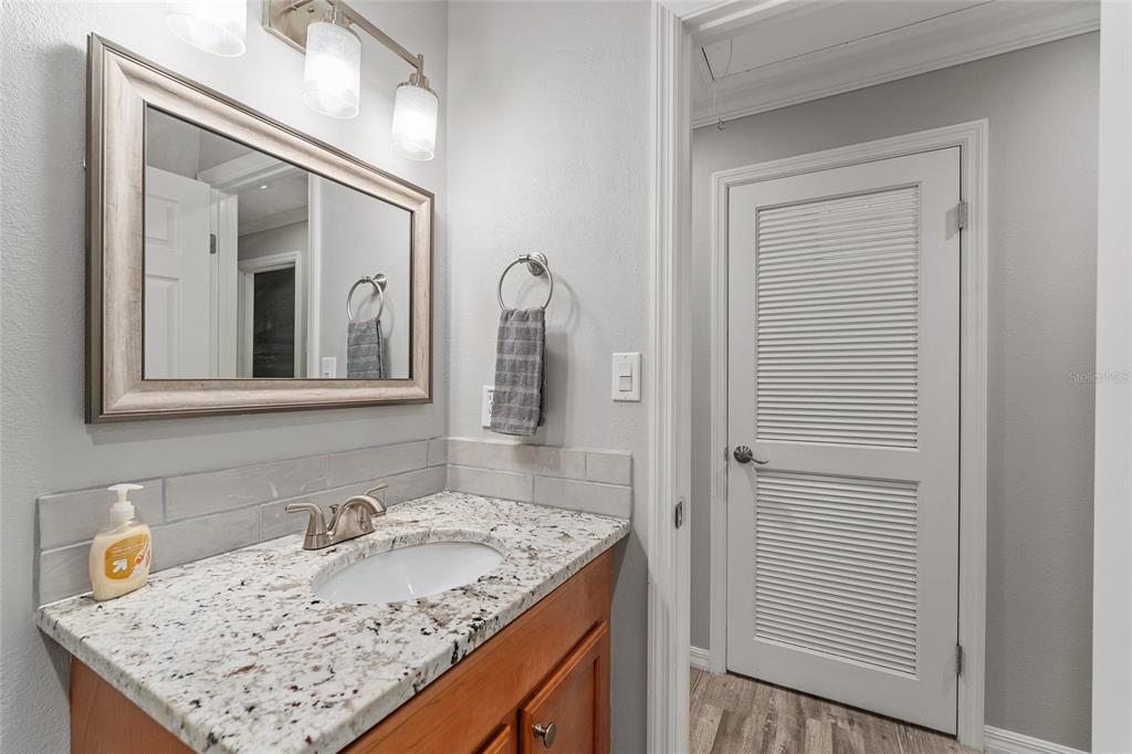 19660 Southwest 83rd Place Road, Unit C13 Dunnellon, FL 34432 - Photo 42 of 52 a bathroom with a granite countertop sink and a mirror