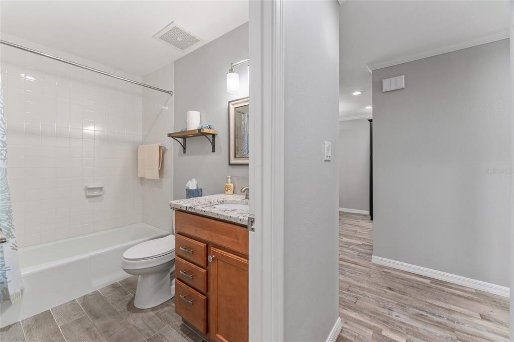 19660 Southwest 83rd Place Road, Unit C13 Dunnellon, FL 34432 - Photo 43 of 52 a bathroom with a granite countertop sink a toilet and shower