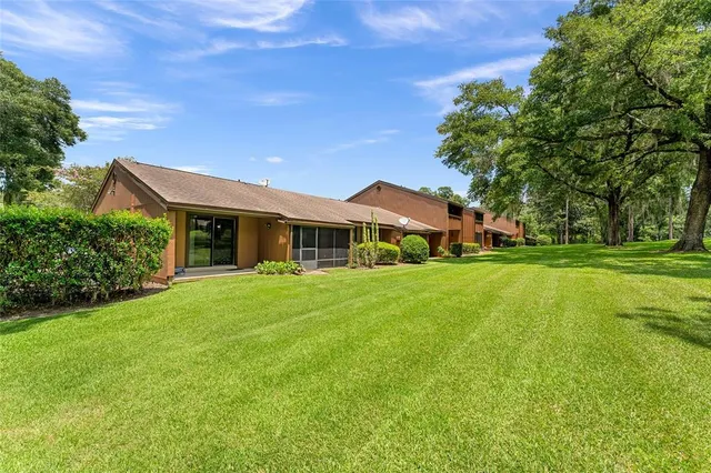 a view of a house with a yard and plants