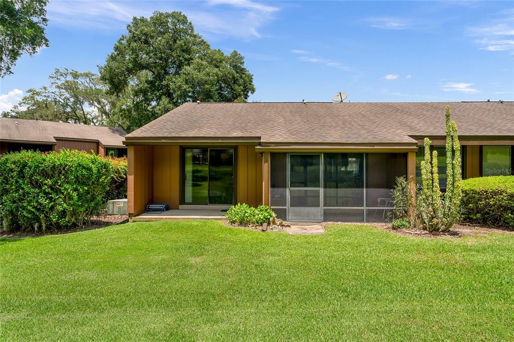 19660 Southwest 83rd Place Road, Unit C13 Dunnellon, FL 34432 - Photo 50 of 52 a front view of a house with garden and porch