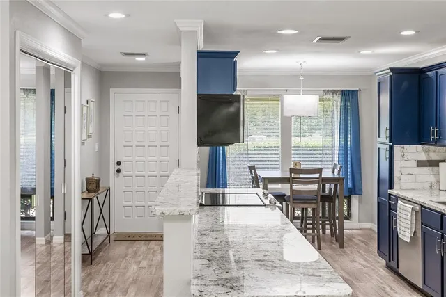 an open kitchen with dining table and chairs