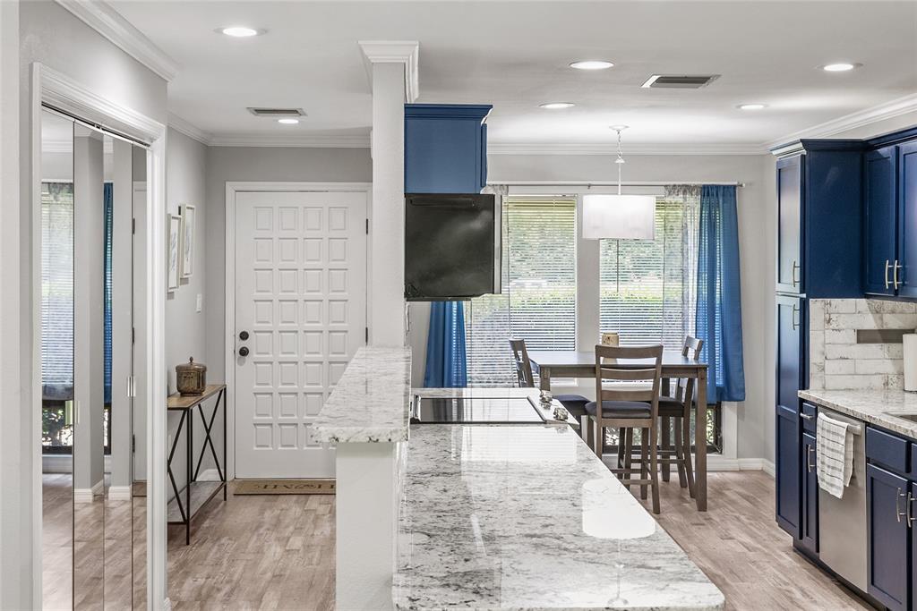 19660 Southwest 83rd Place Road, Unit C13 Dunnellon, FL 34432 - Photo 9 of 52 an open kitchen with dining table and chairs