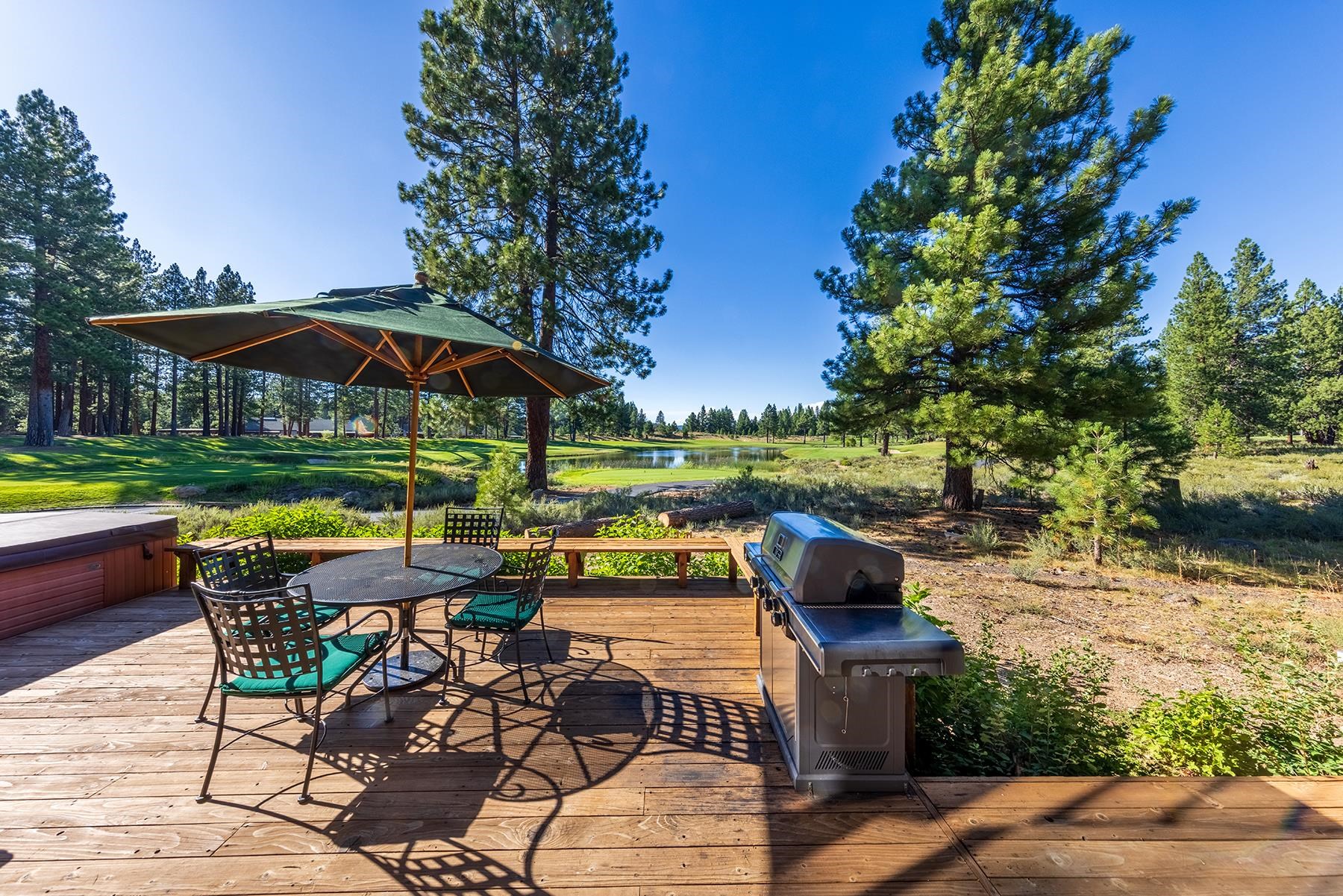 12303 Lookout Loop, Unit F0913 Truckee, CA 96161 - Photo 24 of 28 a view of a patio with chairs and a table under an umbrella