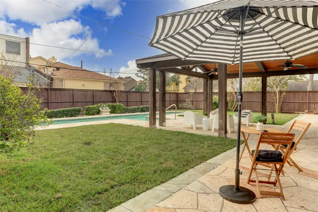 a view of a chair and table in backyard