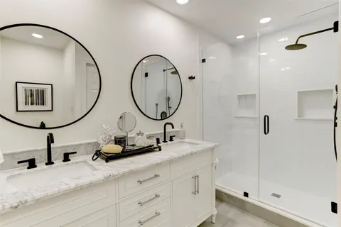 a bathroom with a sink double vanity and a mirror