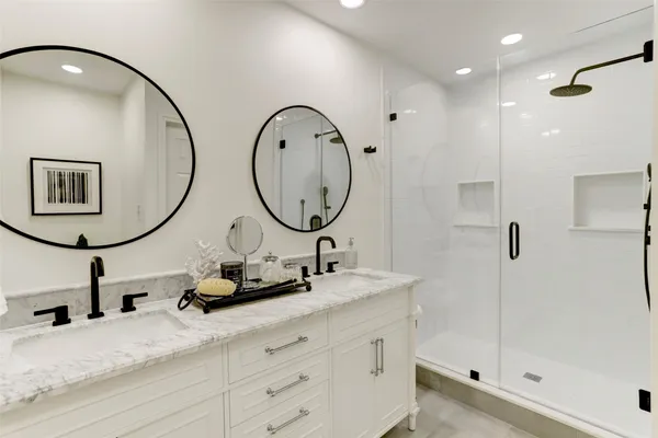 a bathroom with a sink double vanity and a mirror
