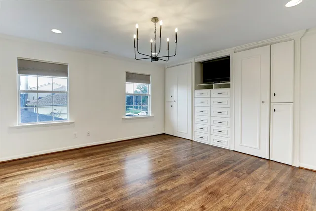 a view of a livingroom with wooden floor windows and chandelier